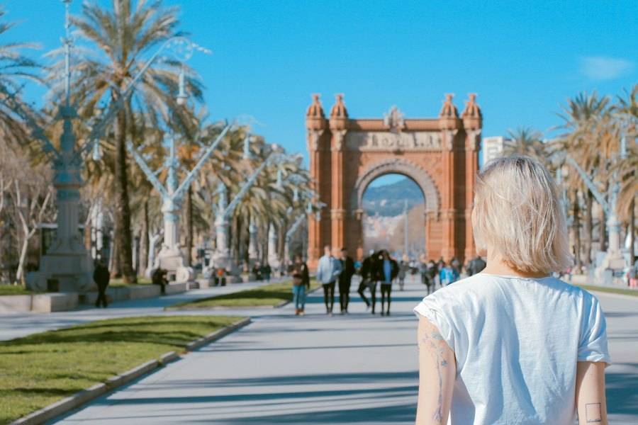 Woman walking towards the Arc de Triomf in Barcelona